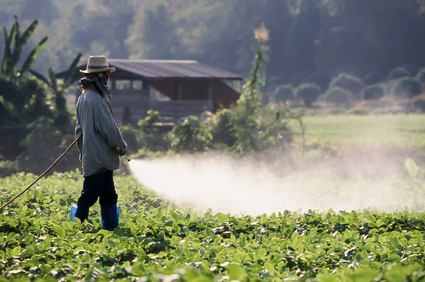 Farmer spraying pesticide on soy field